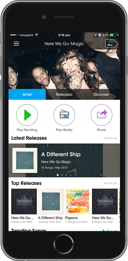 The artist screen for Here We Go Magic, with play trending, play radio and share as round outlined buttons above latest and top releases